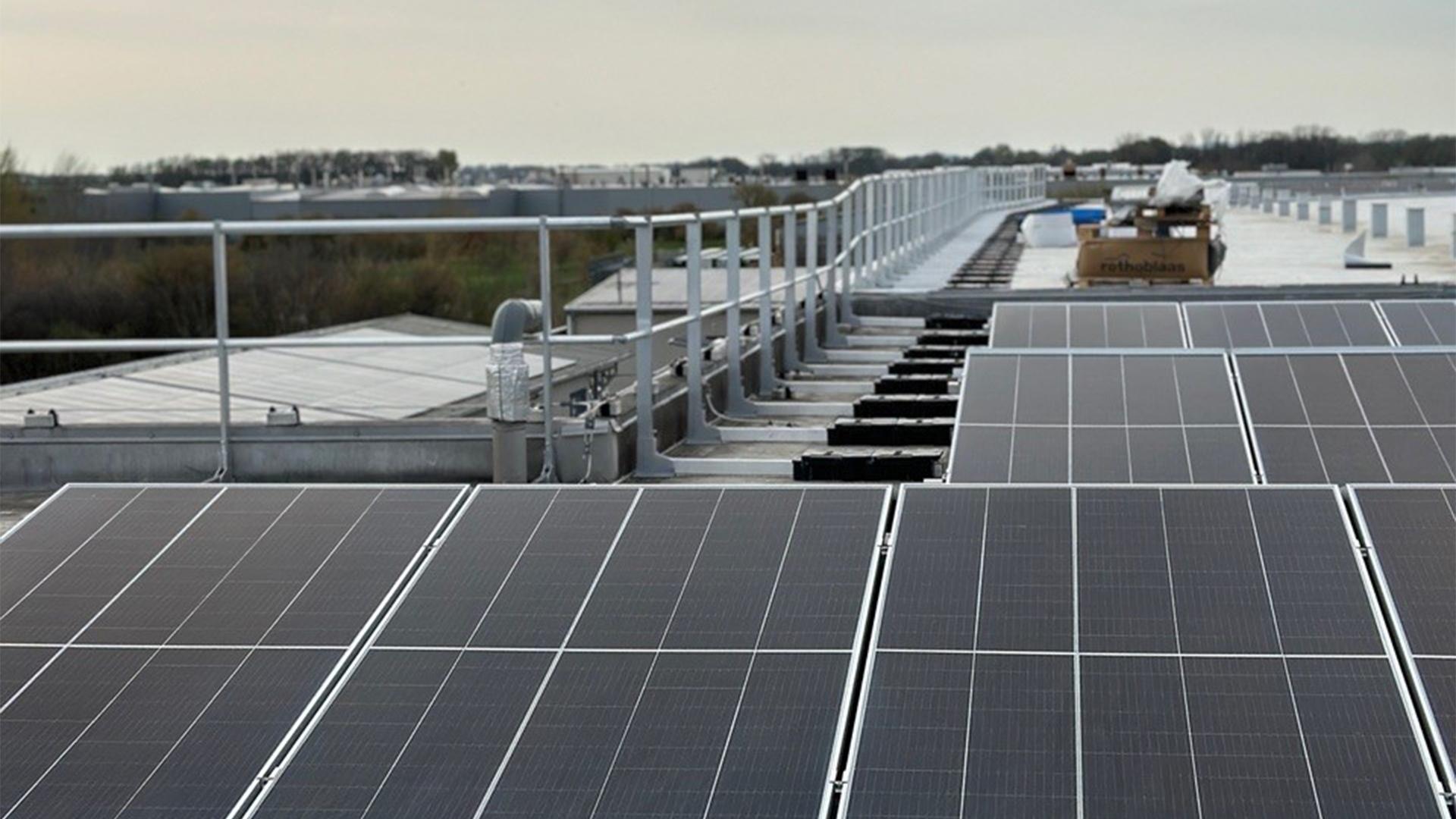 Rooftop solar panel installation with safety guardrails and secured access system.