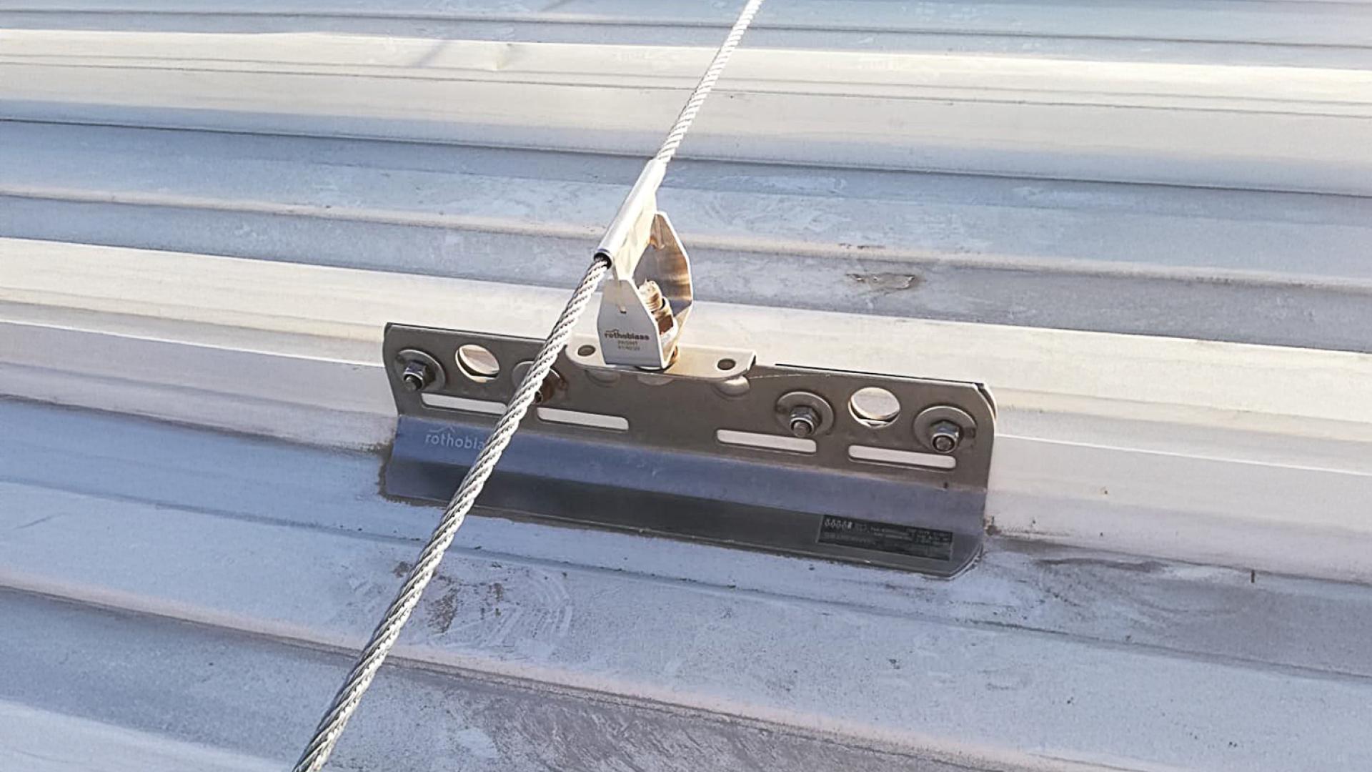 Anchor point installed on standing seam metal roof typical of Latin American constructions 