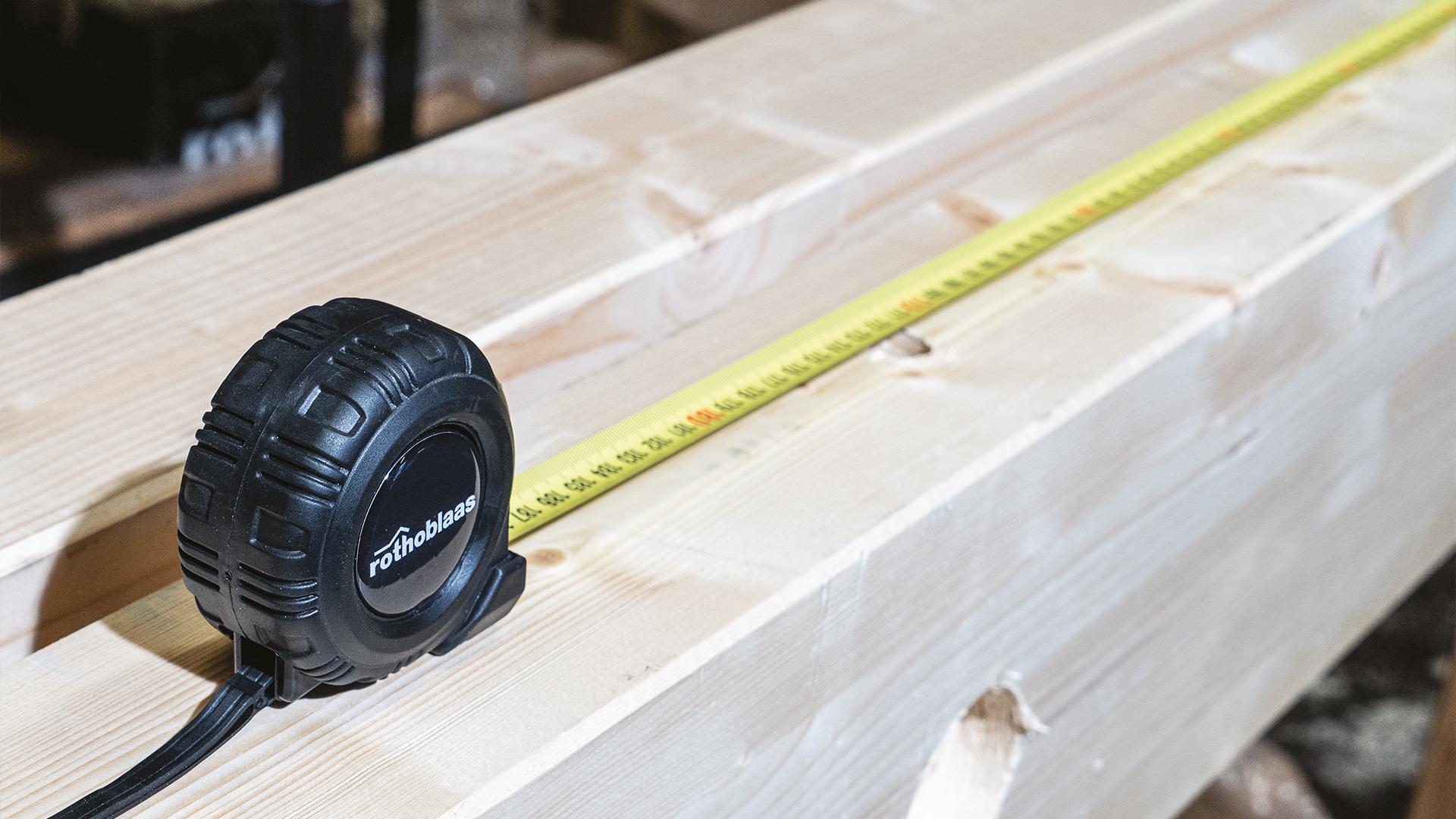  RBMET measuring tape on timber background