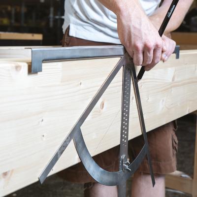 Carpenter’s square in use on timber surface 