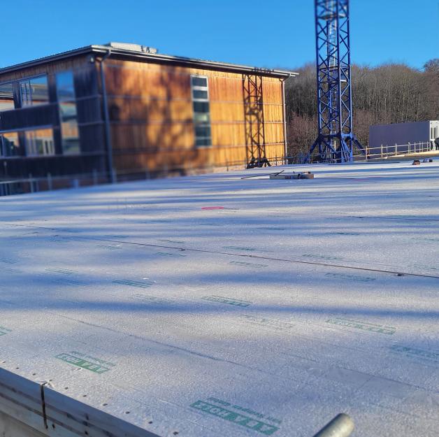 Public school building in CLT under construction in Germany, prefabricated panels ready for assembly