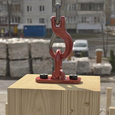 Metal lifting hook and plate fixed to timber element for crane lifting on construction site, designed for handling prefabricated wooden components 