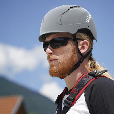Worker wearing the Rothoblaas HERO safety helmet in iconic grey, certified EN 397:2025 Type II, in a work-at-height context