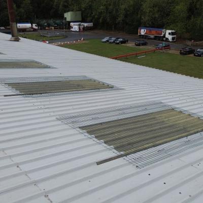 Skylight fall protection system installed on industrial metal roof to secure fragile rooflights during maintenance 