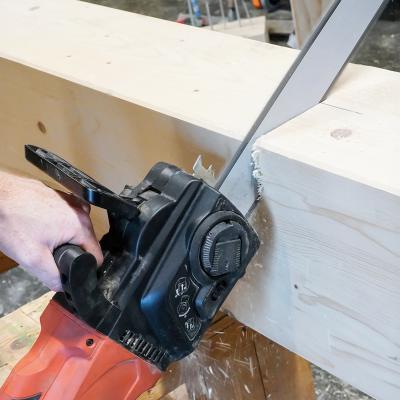 Professional woodworking machine cutting a solid timber beam with a woodworking chainsaw, used in structural timber carpentry