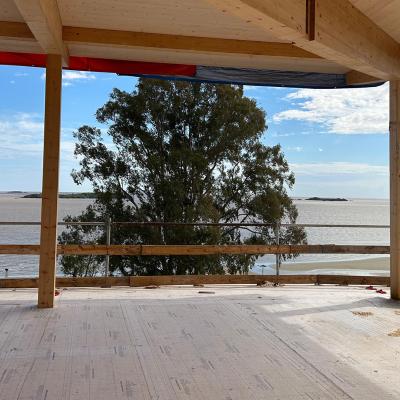 Mass timber structure under construction with CLT floor overlooking Río de la Plata, Uruguay