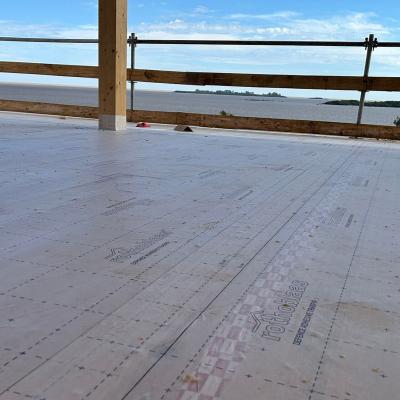 Self-adhesive membrane installed on timber floor slab during construction overlooking Río de la Plata