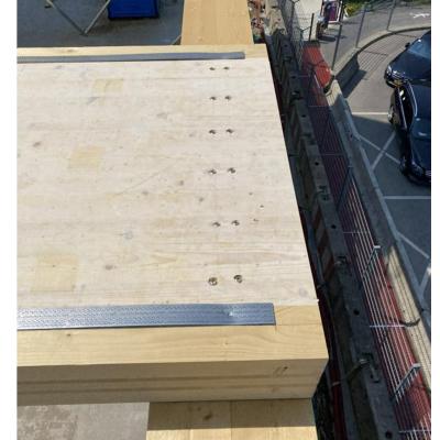 Timber floor slab with protective membrane installed on mass timber structure during construction 