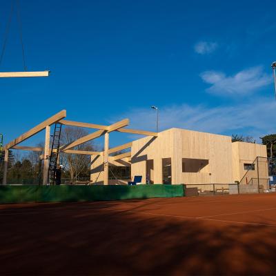 Timber pavilion construction with glulam beams and CLT structure at tennis club site