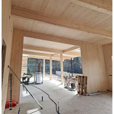 Interior of timber pavilion with exposed CLT panels and glulam beams 