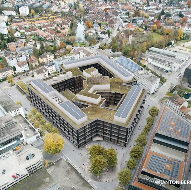 Aerial view of Biel campus with large-scale engineered timber building and post and beam structure integrated in urban context 