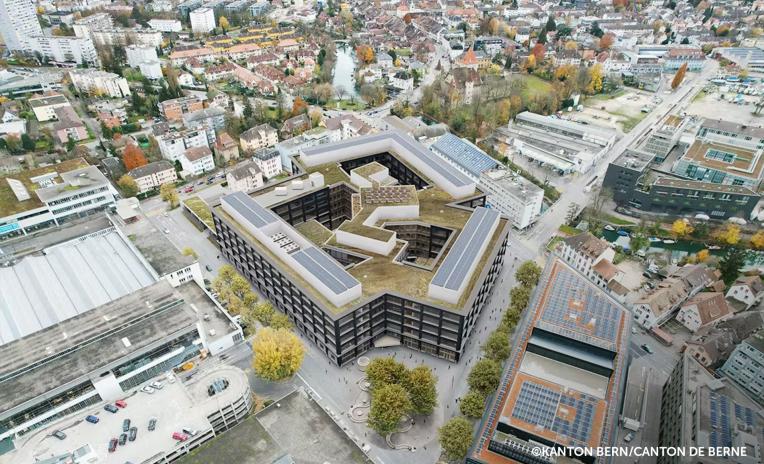 Aerial view of Biel campus with large-scale engineered timber building and post and beam structure integrated in urban context 