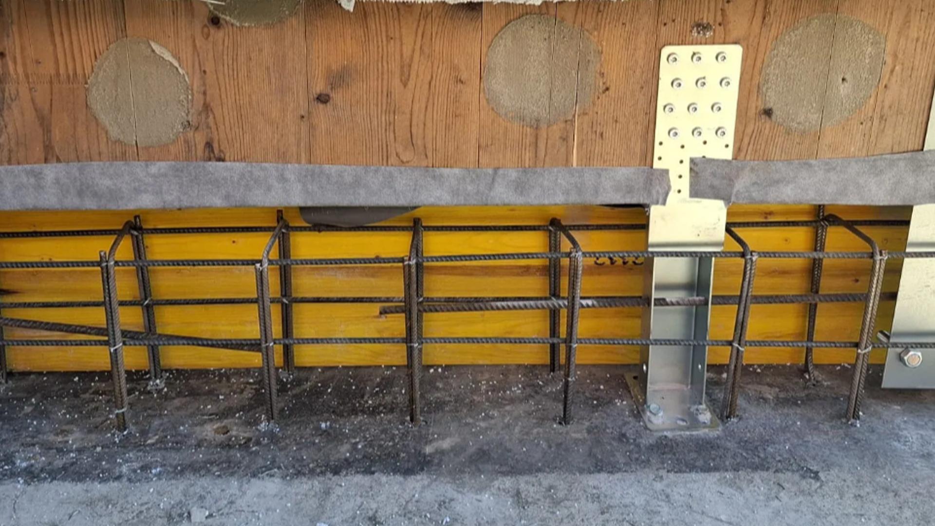 X-LAM structural retrofit detail with UP LIFT system, base connection reinforcement and concrete foundation preparation
