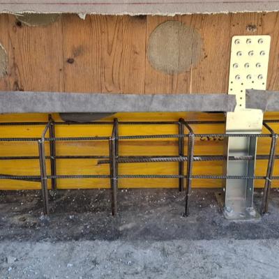 X-LAM structural retrofit detail with UP LIFT system, base connection reinforcement and concrete foundation preparation