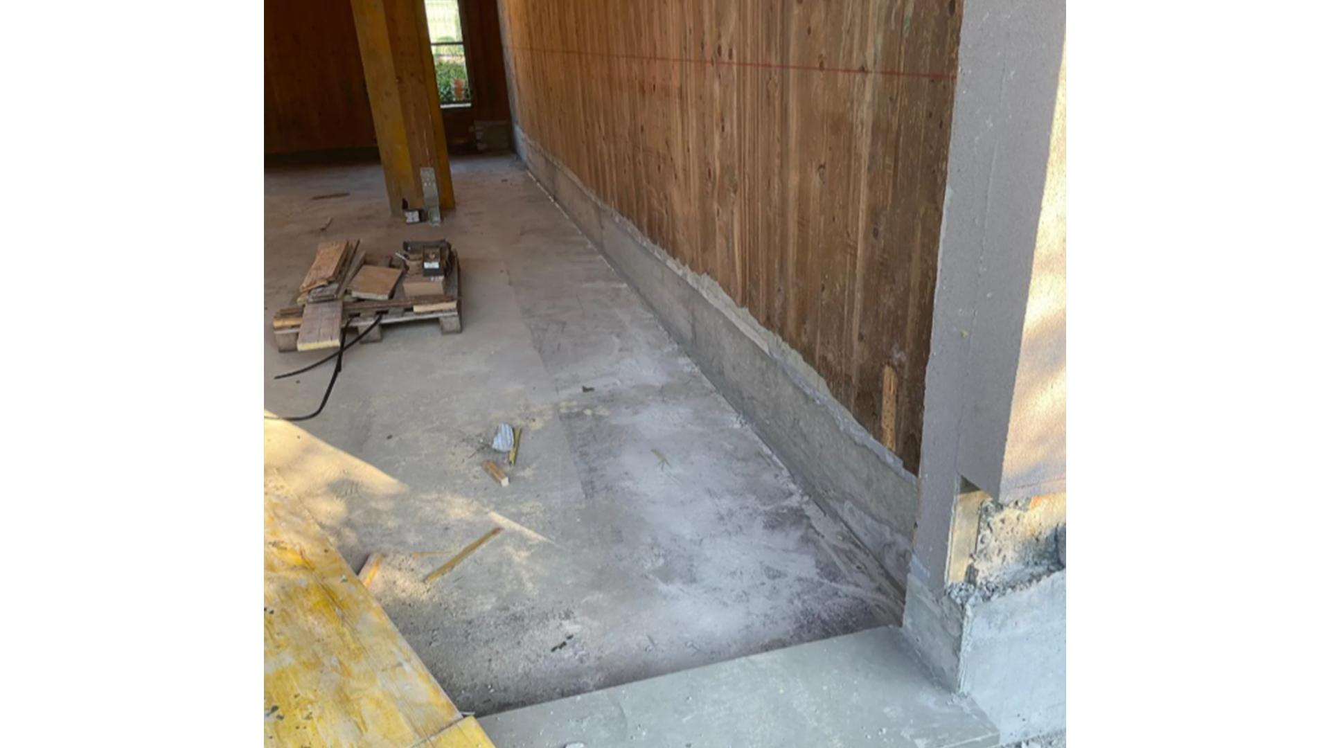 Completed timber building retrofit with restored X-LAM base connection and concrete foundation upgrade