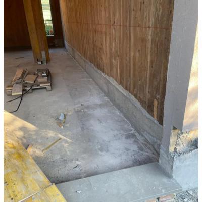 Completed timber building retrofit with restored X-LAM base connection and concrete foundation upgrade