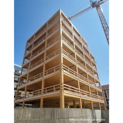 Timber construction site with temporary safety guardrails for prefabricated facade installation and off-site building retrofit