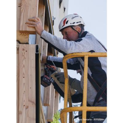 Installation of prefabricated timber facade with mechanical connections during off-site retrofit on existing building