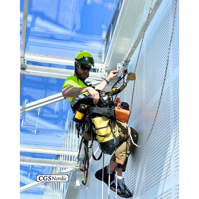  CGS Nordic technician installing H-RAIL rigid rail track on steel structure under glazed roof, using professional power tools during installation of rope access system