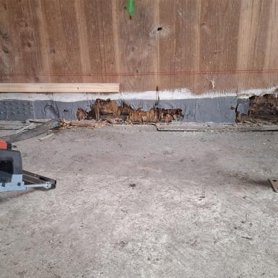 Timber building retrofit with decayed base detail and lifting system for X-LAM structural repair