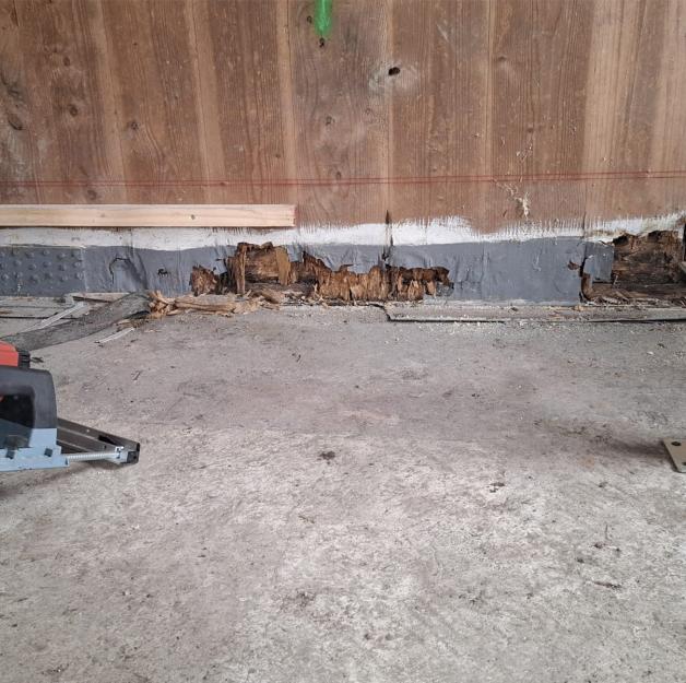 Timber building retrofit with decayed base detail and lifting system for X-LAM structural repair