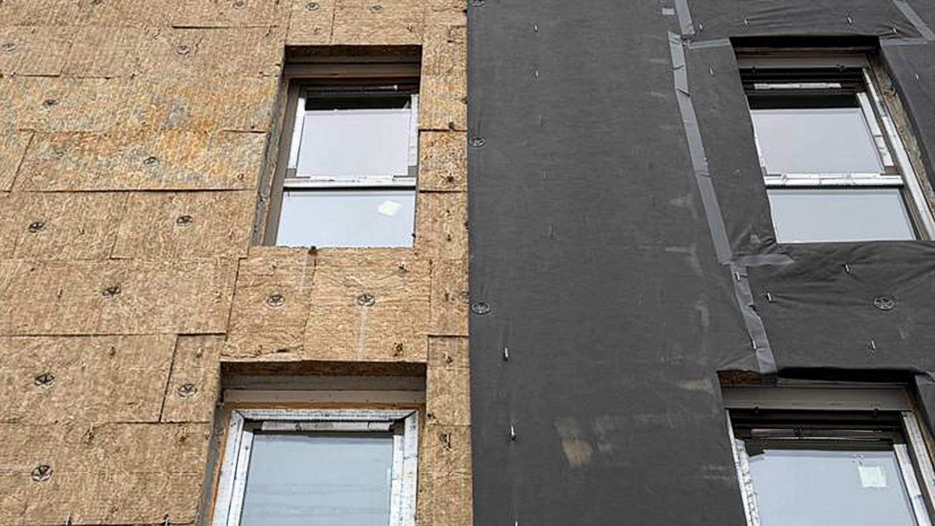 Breathable membrane installed over mineral wool insulation in a ventilated façade system during construction