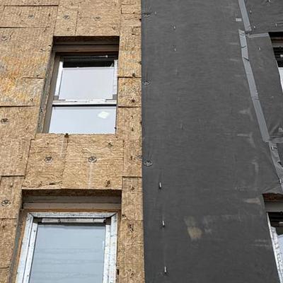 Breathable membrane installed over mineral wool insulation in a ventilated façade system during construction