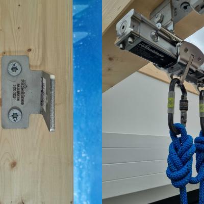 Rothoblaas H-RAIL sliding runner with two locking carabiners and blue ropes attached — rope access system ready for use on a timber and glass roof structure, Denmark.
