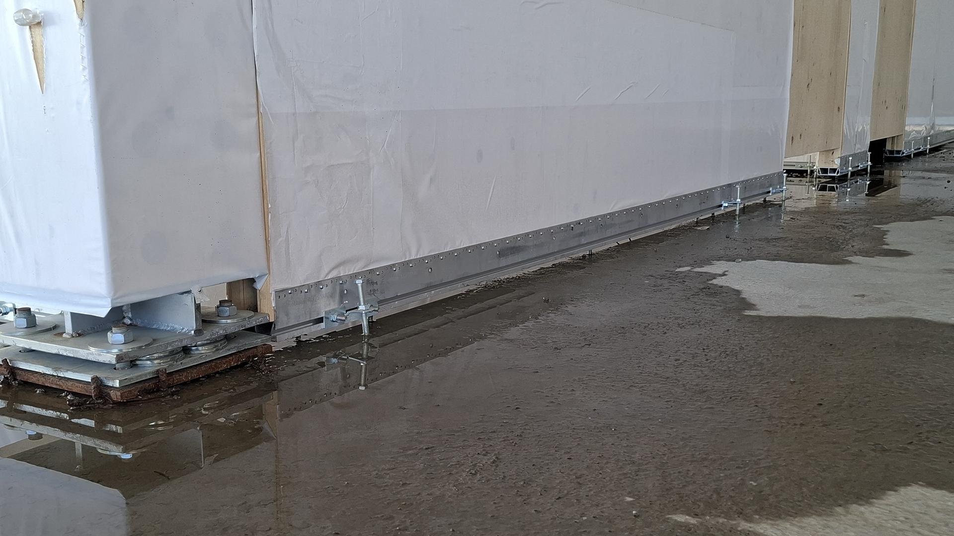 ALU START profile protecting timber panel base from rising damp on site