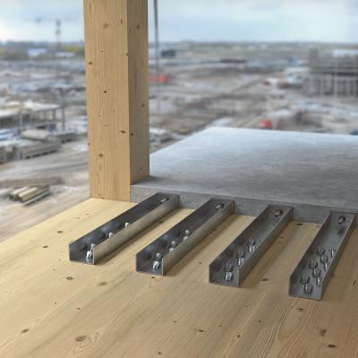 Steel WHTVG900 connectors fixed on a cross-laminated timber floor slab next to a precast reinforced concrete cantilever balcony slab on a multi-storey timber building site.